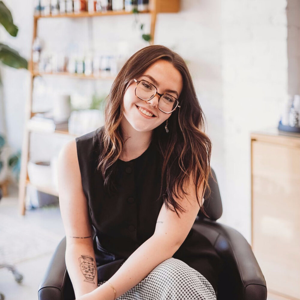 Morgan Winfield, stylist at Linden Salon, seated in the salon